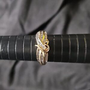 10 carat gold with small diamonds and the crafted into each side. Very unique